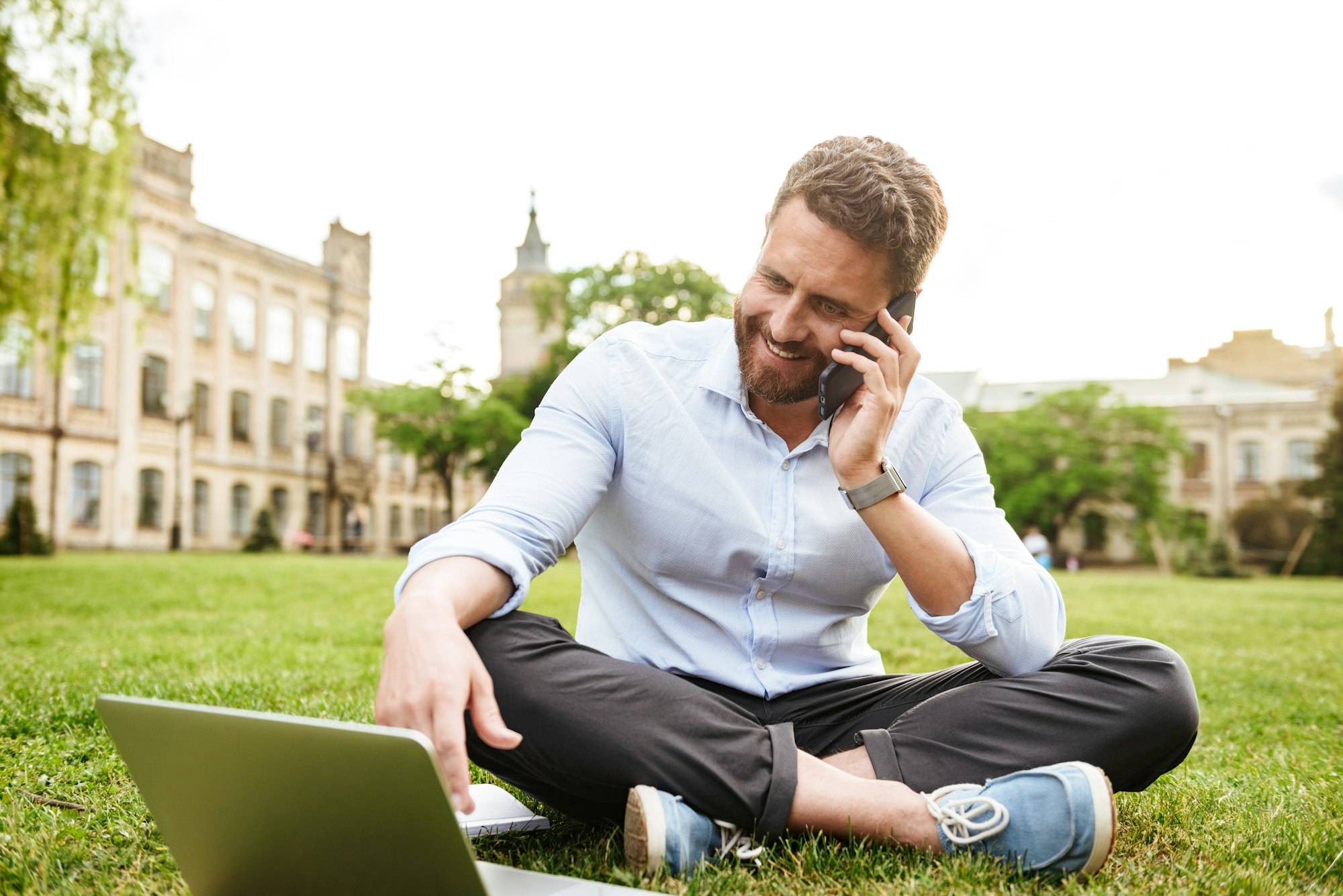 Image of content european man 40s in business clothing, sitting