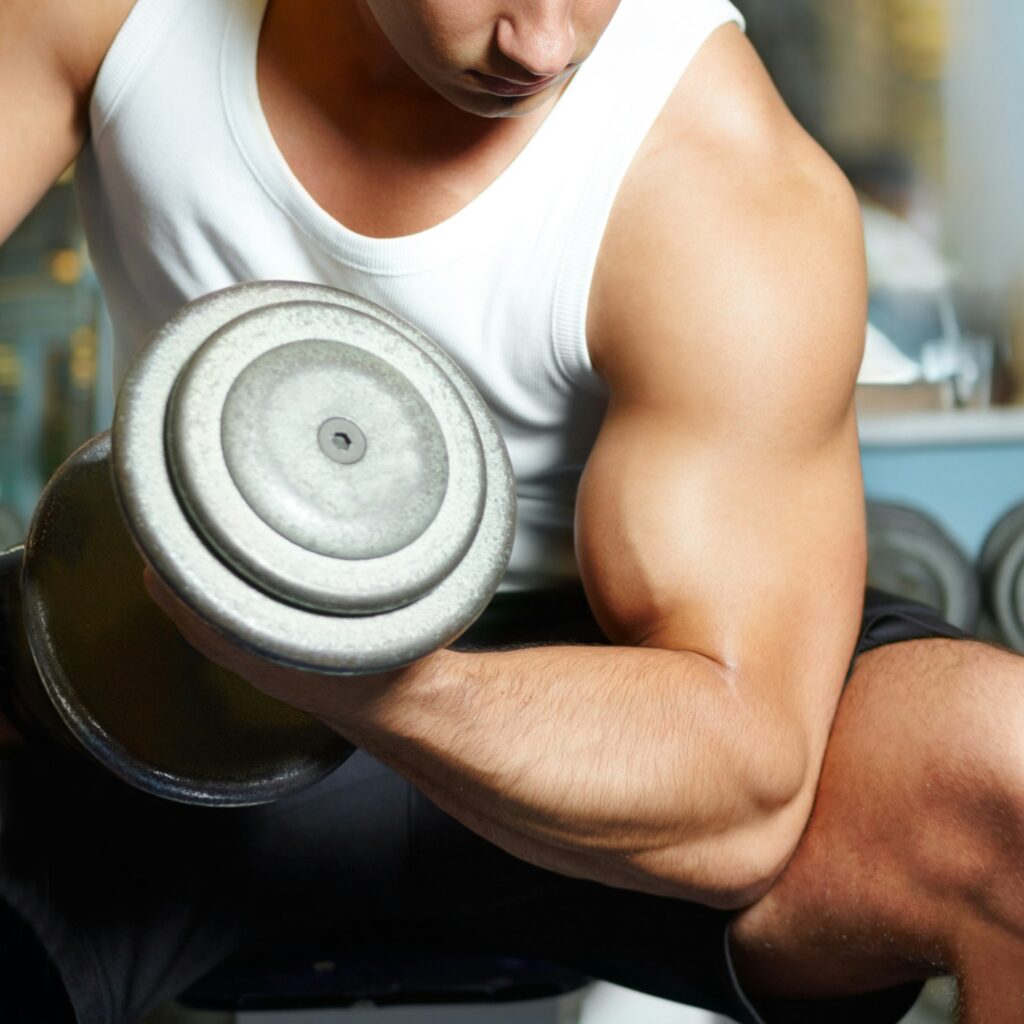 Feel the burn on those biceps. Cropped shot of a muscular young man working out in the gym.