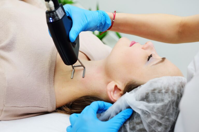 cosmetologist uses a CO2 fractional ablative laser to rejuvenate the skin and remove scars in a