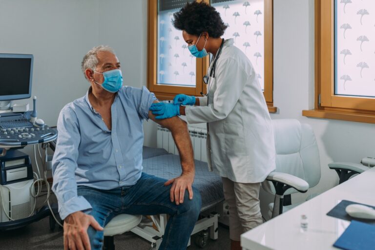 African american doctor injecting vaccine into patient's arm