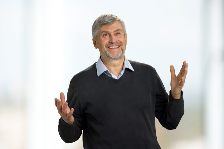 Excited mature man on white background.