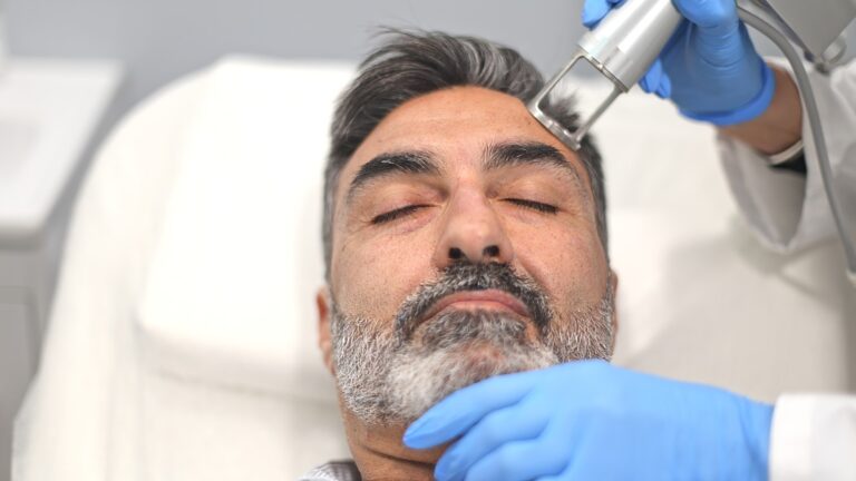 Male patient receiving advanced skin treatment at a beauty clinic.