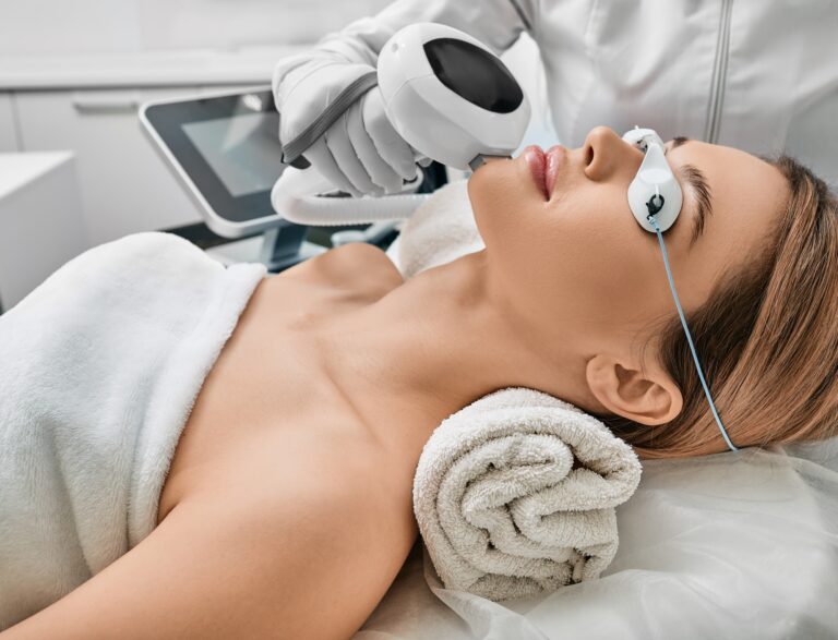 Photorejuvenation, rosacea treatment, removing brown spots and vascular mesh. Cosmetologist using