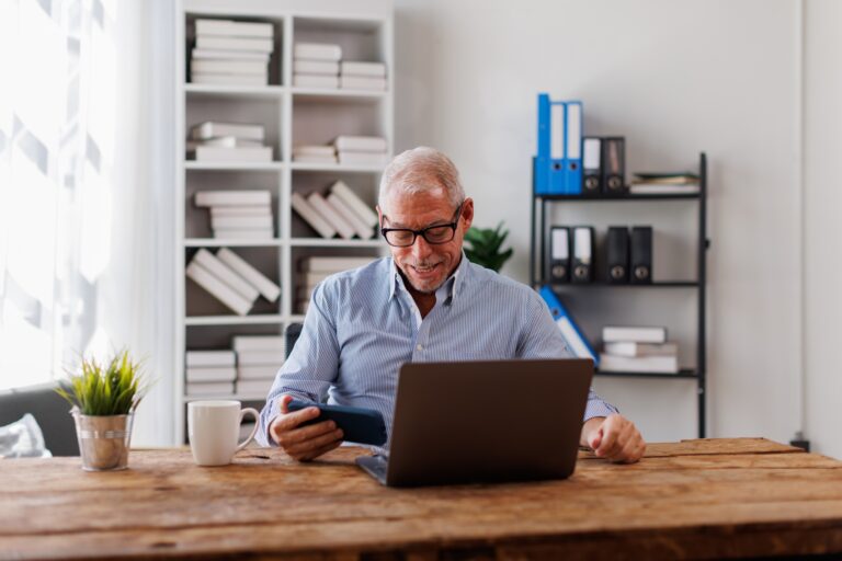 Portrait of around the age of 50s,Happy handsome Senior, man or businessman looking at phone making