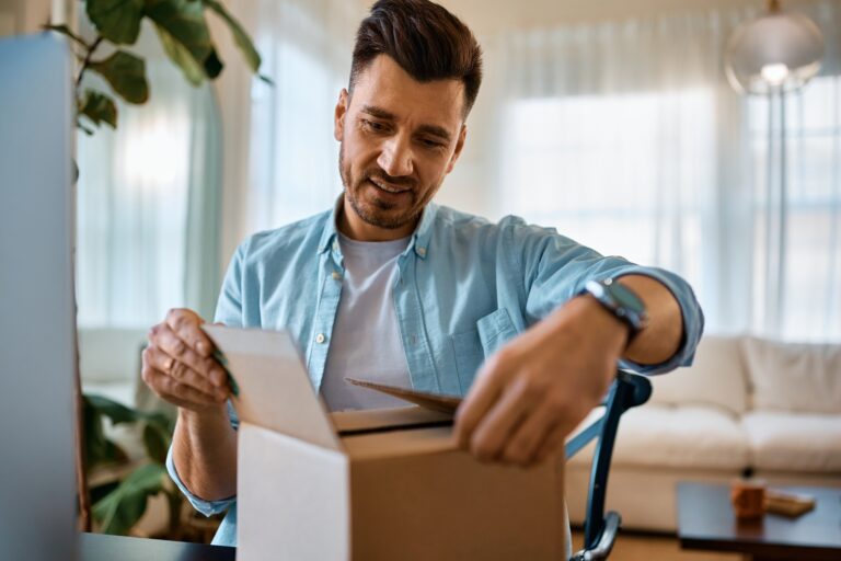 happy-man-unboxing-home-delivered-package--768x512