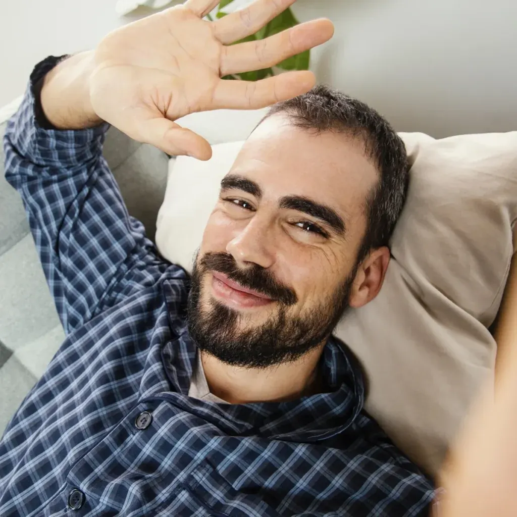 Man on a video call at home representing connected care and follow-up