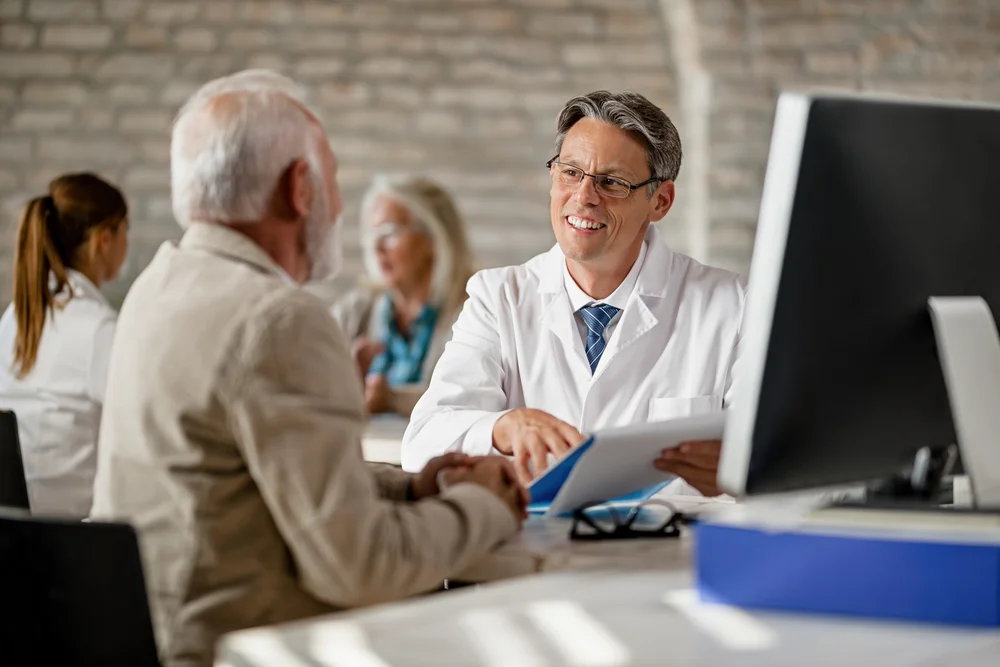 Smiling doctor discussing results with a patient